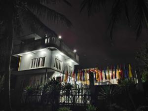 a building with flags in front of it at night at Private Home Ocean View Resort Talaonga in Sorsogon