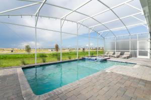 a swimming pool in a marquee with a swimming poolvisor at 9312 SH - Champions Gate - Unique High end 8 Beds in Davenport