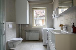 a white bathroom with a toilet and a sink at Upper Town Apartments in Zagreb +21 photos