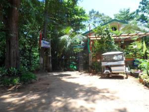 a house with a car parked in the driveway at Victoria Guest House and Cottages in Puerto Princesa City