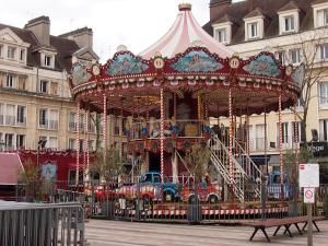 a carousel in front of a building at Le Nid Douillet - Hypercentre - Studio in Beauvais