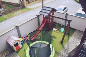 a playground with a slide and a swing at Penzión Carlos in Podlužany