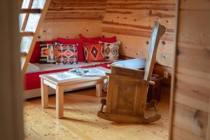 a living room with a couch and a table at Šumska priča Tara / A Forest Tale Tara in Mokra Gora