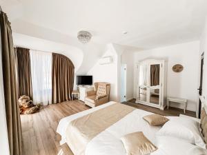 a bedroom with a bed and a dog sitting on the floor at Complex Vila Rania in Satu Mare