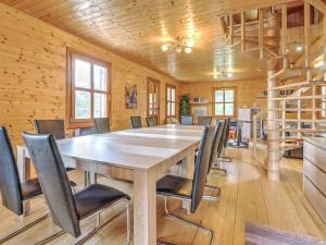 a conference room with a wooden table and chairs at Detached wooden chalet in Liebenfels Carinthia near the Simonh he ski area in Liebenfels