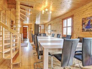 a dining room with a table and chairs at Detached wooden chalet in Liebenfels Carinthia near the Simonh he ski area in Liebenfels