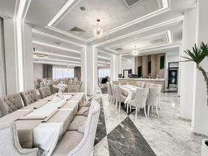 a dining room with white tables and chairs at Complex Vila Rania in Satu Mare
