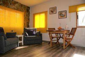 a living room with a table and chairs at Vivienda Vacacional Cuenca de Liria in Hermigua +14 photos