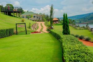 a house on a hill with a green yard at GOOD MOOD BEACH RESORT LTD in Rwamagana