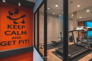 a gym with a sign that says keep calm and get fit at Recenta Style Phuket Town in Phuket Town