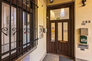 an entrance to a building with a wooden door at Amber Gardenview Studios Downtown in Budapest