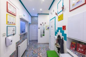 a bathroom with a tile floor and a hallway at Amber Gardenview Studios Downtown in Budapest