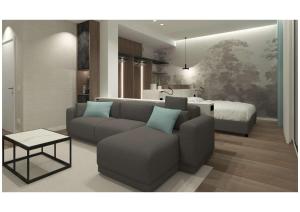 sala de estar con sofá y cama en Litoraneo Suite Hotel, en Rímini