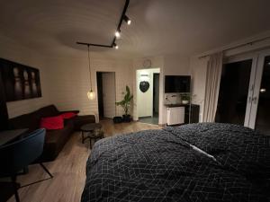 a bedroom with a bed and a living room at Apartment Hideaway in Bad Oeynhausen