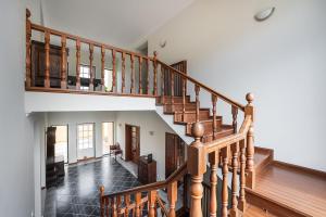 a staircase in a home with wooden railings at GuestReady - Quinta do Sol in Mealhada