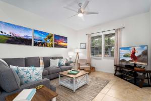 a living room with a couch and a table at Fairways at Mauna Lani #1703 in Kawailiula