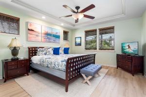 a bedroom with a bed and a ceiling fan at Fairways at Mauna Lani #1703 in Kawailiula