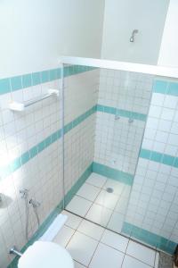 a bathroom with a shower and a sink at Hotel Paranoá in Guaíra