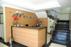 a lobby of a hotel with a counter and stairs at Hotel Paranoá in Guaíra