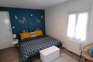 a bedroom with a bed with butterflies on the wall at Chez Odette et Ricardo Meximieux - Pérouges in Meximieux