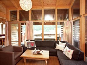 a living room with a couch and a coffee table at Luxurious chalet with sauna in K nigsleiten in Wald im Pinzgau