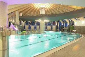a large swimming pool in a large building at Luxurious chalet with sauna in K nigsleiten in Wald im Pinzgau