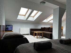 a living room with two beds and a couch at Apartament Serwis in Krakow