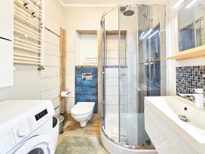 a bathroom with a toilet sink and a shower at visit baltic - Kwartał Róży Wiatrów apartament SK30 z parkingiem in Świnoujście +33 photos
