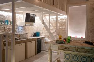 a kitchen with a wooden table in a room at Diamond Suite Puglia in Ceglie Messapica