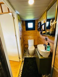 a small bathroom with a toilet and a sink at Yucca tiny house in Orta