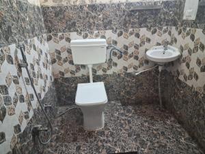 a bathroom with a toilet and a sink at Gorakhnath Guest House in Gorakhpur