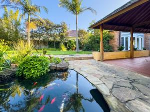 a koi pond in the backyard of a house at Elegant Bayside Retreat with Stunning Bay Views in Melbourne