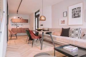 a living room with a couch and a table at The Guest Apartments in Den Bosch
