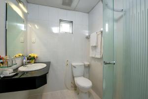 a bathroom with a toilet and a sink and a shower at Palago Park View Hotel in Ho Chi Minh City