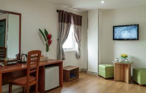 a living room with a desk and a window at Palago Park View Hotel in Ho Chi Minh City