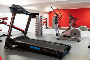 a gym with two exercise bikes and a treadmill at Bliżej Morza Apartament 57 in Kołobrzeg