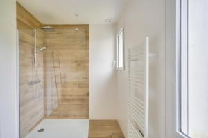 a bathroom with a shower with a glass door at Belle maison pour 6 - Découverte du Pays Bigouden in Plonéour-Lanvern +16 photos