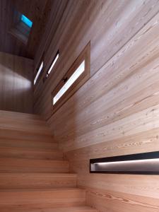 uma escada de madeira num quarto com 2 janelas em Mountain Lodge Tamersc em San Vigilio Di Marebbe