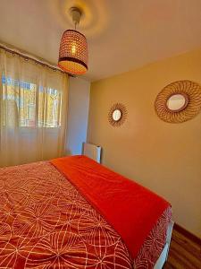 a bedroom with a red bed and two mirrors at Rousseau in Théoule-sur-Mer