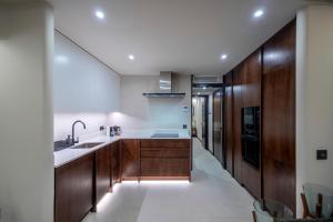 a kitchen with wooden cabinets and a sink at PRB Aparment Puerto del Carmen in Puerto del Carmen