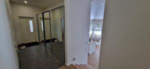 a hallway with a glass shower in a building at Villa Koivunoksa in Kerava +11 photos