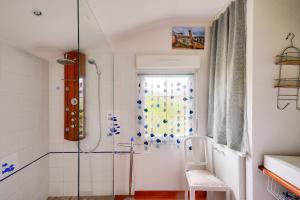 a bathroom with a shower with a glass door at Maison avec terasse et jardin - 1km plage de Kérity in Kérity +14 photos