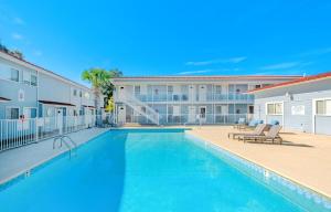 a swimming pool in front of a apartment building at Oak Shores Studio 39 in Biloxi