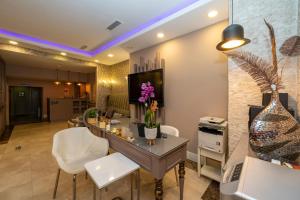 a living room with a table and white chairs at Raymond Hotel in Istanbul