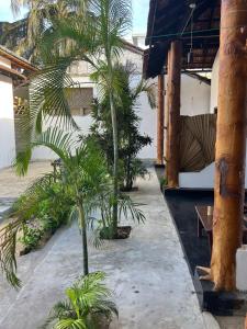 a courtyard with palm trees in front of a building at Emerald Bay in Arugam Bay