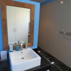 a bathroom with a white sink and a mirror at Pandana Boutique Hotel in Nusa Lembongan