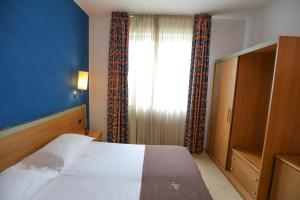 Postel nebo postele na pokoji v ubytování Palace Hotel Due Ponti