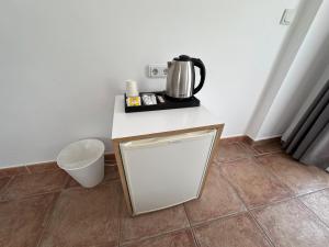 a counter with a coffee pot on it in a room at Mimosa Pension in Kas
