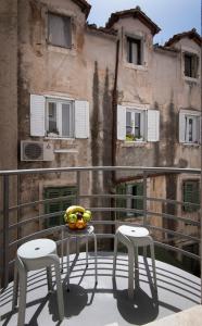 a bowl of fruit sitting on a table on a balcony at City Centre Apartment Iva in Split