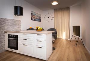 a kitchen with a white counter top and a tv at City Centre Apartment Iva in Split